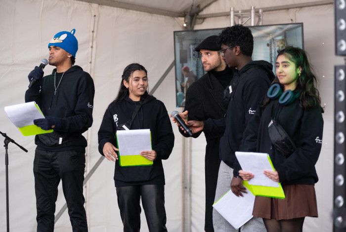 A group of young people MCing on stage