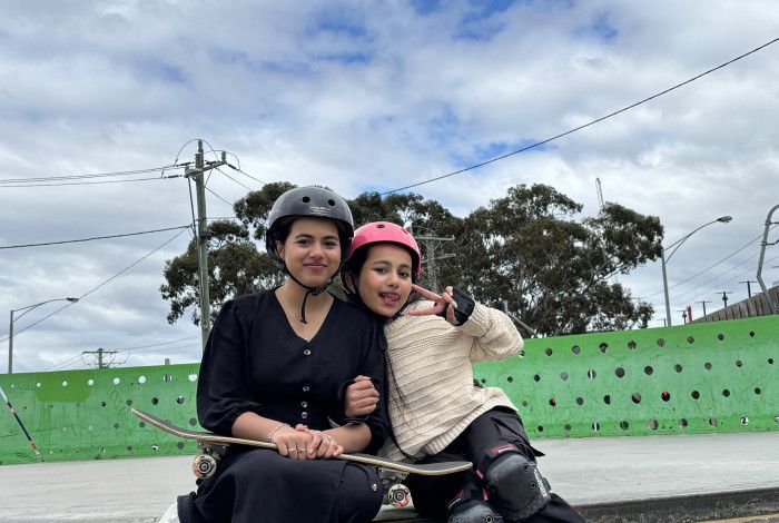 young people smiling with skateboard