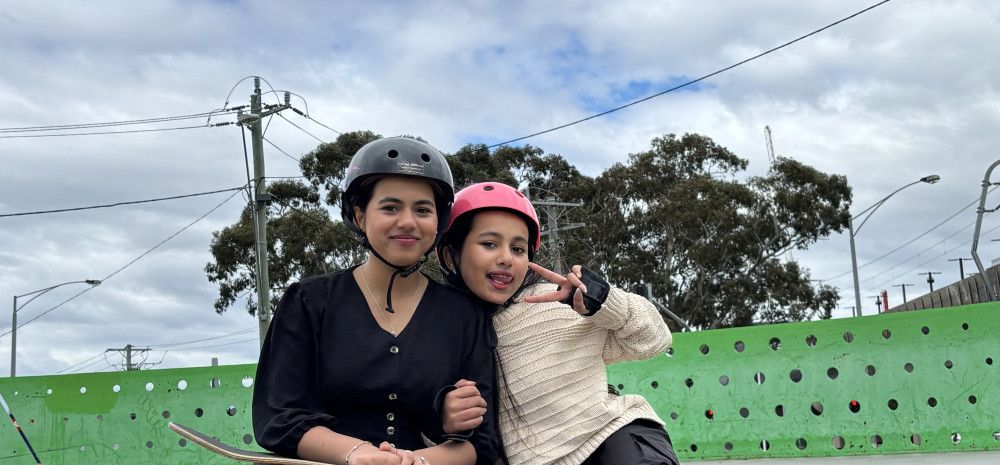 young people smiling with skateboard