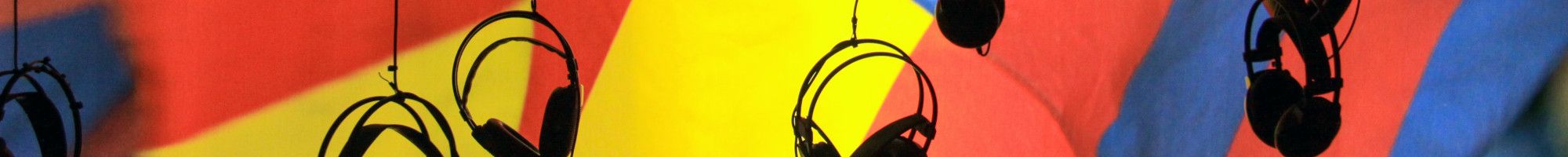 head sets hanging in front of a coloured wall