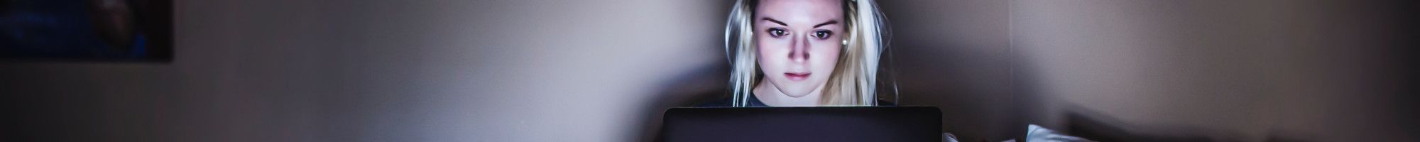 youth in bed on laptop