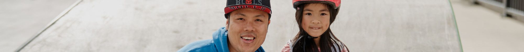 Father and daughter at skate park
