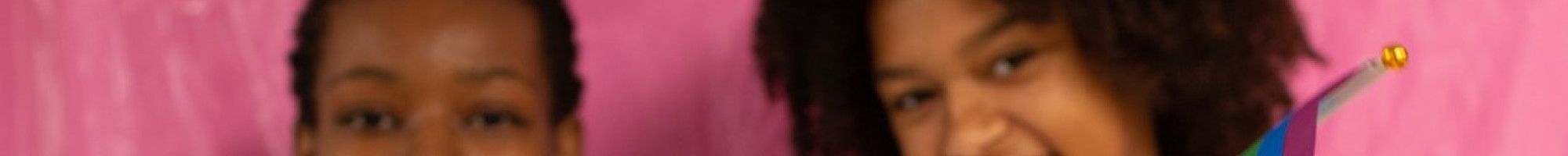 Young people waving rainbow pride flags